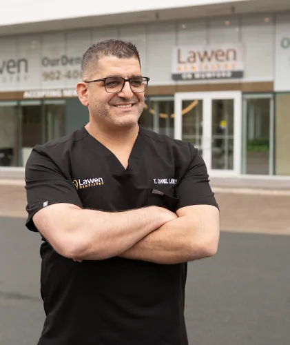 Dr. Daniel Lawen, DDS smiling in front of the Mumford Road Clinic