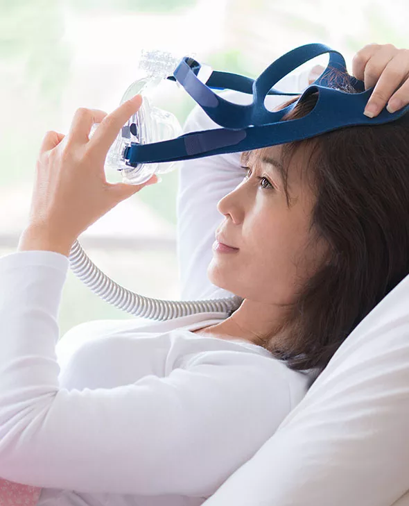 Woman using CPAP machine